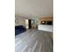 Open living room with gray flooring and a dining area at 107 S Obrien St # 220, Tampa, FL 33609