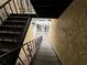Exterior back stairwell with wrought iron railings and a gated entry at 107 S Obrien St # 220, Tampa, FL 33609