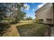 Home's backyard featuring a lush lawn with a golf course view on a sunny day at 113 Lindsay Ln # 23, Oldsmar, FL 34677