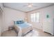 Cozy bedroom with tile floors, a comfortable bed, and a large window at 113 Lindsay Ln # 23, Oldsmar, FL 34677