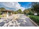 Community entrance security gate with access control and lush landscaping at 113 Lindsay Ln # 23, Oldsmar, FL 34677