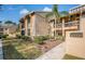 Well-maintained condo exterior with lush landscaping and a welcoming entryway at 113 Lindsay Ln # 23, Oldsmar, FL 34677