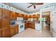 Efficient kitchen with lots of wood cabinets, granite counters, and convenient layout at 113 Lindsay Ln # 23, Oldsmar, FL 34677