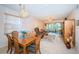 Open-concept living and dining area with travertine floors and plenty of natural light at 113 Lindsay Ln # 23, Oldsmar, FL 34677