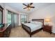 Well-lit bedroom with a large window, ceiling fan, and a coordinated furniture set at 113 Lindsay Ln # 23, Oldsmar, FL 34677