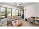 Bright sun room with large windows, a comfortable seating area, and an outdoor view at 113 Lindsay Ln # 23, Oldsmar, FL 34677