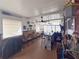Entertaining bar area complete with seating, bar, ceiling fans, and a view through the windows at 117 S Saint Thomas Cir, Apollo Beach, FL 33572