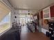 Entertaining bar area complete with seating, bar, ceiling fans, and a view through the windows at 117 S Saint Thomas Cir, Apollo Beach, FL 33572