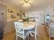 Elegant dining room with a round table, white chairs, and seamless access to the kitchen at 117 S Saint Thomas Cir, Apollo Beach, FL 33572