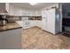 Bright kitchen featuring white cabinets, modern appliances, and a neutral color scheme at 117 S Saint Thomas Cir, Apollo Beach, FL 33572