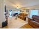 Cozy living room with comfortable seating, a decorative fireplace, and stylish decor at 117 S Saint Thomas Cir, Apollo Beach, FL 33572