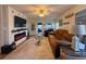 Comfortable living room featuring a fireplace, a ceiling fan, and plush seating at 117 S Saint Thomas Cir, Apollo Beach, FL 33572