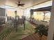 Relaxing screened patio with an outdoor dining area overlooking a spacious backyard and lush landscaping at 117 S Saint Thomas Cir, Apollo Beach, FL 33572