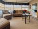 Bright sunroom with wicker furniture, a glass-top table, and natural light streaming through the windows at 117 S Saint Thomas Cir, Apollo Beach, FL 33572