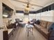 A cozy sunroom boasts comfortable seating and ample natural light, perfect for relaxing or entertaining guests at 117 S Saint Thomas Cir, Apollo Beach, FL 33572