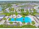 An aerial view of the community and oversized community pool with tropical landscaping and lounge area at 11811 Meadowgate Pl, Bradenton, FL 34211