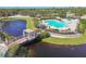 A beautiful community pool area with a bridge, lounging areas and umbrellas at 11852 Whisper Creek Dr, Riverview, FL 33569