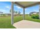 Large backyard with covered patio and partial view of other homes at 11868 Little River Way, Parrish, FL 34219