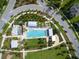 Community aerial view showcasing a resort-style pool, splash pad and surrounding neighborhood at 12099 Gavin Ln, Odessa, FL 33556