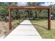 Walking path in Albritton Park, featuring a sidewalk, a welcoming sign and plenty of trees at 12099 Gavin Ln, Odessa, FL 33556