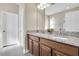 Spacious bathroom features a double sink vanity with granite countertops at 12099 Gavin Ln, Odessa, FL 33556