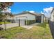Beautiful home exterior with well-manicured lawn, hedges, fenced yard and a paved driveway at 12099 Gavin Ln, Odessa, FL 33556