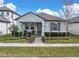 Charming single-story home with a well-manicured front yard, covered entryway, and a cozy front patio at 12099 Gavin Ln, Odessa, FL 33556