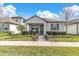 Charming one-story house with a well-manicured lawn and inviting front porch at 12099 Gavin Ln, Odessa, FL 33556