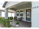 Inviting front porch with seating, potted plants, and a view of the neighborhood at 12099 Gavin Ln, Odessa, FL 33556