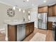Well-equipped kitchen with stainless steel appliances, granite counters, and a functional layout at 12099 Gavin Ln, Odessa, FL 33556