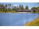 Scenic view of lake, showcasing the clubhouse with glass walls, and wooden decks at 12099 Gavin Ln, Odessa, FL 33556