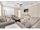 Bright living room showcasing a ceiling fan, tv, and stylish decor at 12099 Gavin Ln, Odessa, FL 33556