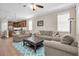 Comfortable living room featuring neutral walls, ceiling fan, and an open view into the kitchen at 12099 Gavin Ln, Odessa, FL 33556