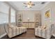 Charming living room with decorative chairs, wooden cabinets, and lots of natural light at 12099 Gavin Ln, Odessa, FL 33556