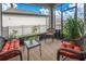 Relaxing screened-in patio with comfortable wicker seating, a glass table and nice landscaping at 12099 Gavin Ln, Odessa, FL 33556