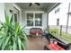 Inviting patio with comfortable wicker seating, a glass table and tall landscaping providing privacy at 12099 Gavin Ln, Odessa, FL 33556
