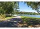 Scenic view of the neighborhood pond with trees and walking path at 12099 Gavin Ln, Odessa, FL 33556