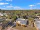 Aerial view of home surrounded by mature trees highlighting the property's setting in a quiet neighborhood at 1276 Bermuda St, Clearwater, FL 33755