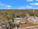 Aerial view of a single-Gathering home showcasing its location in a wooded neighborhood at 1276 Bermuda St, Clearwater, FL 33755