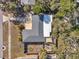Detailed aerial view of the property featuring a large, well-maintained roof, spacious driveway, fenced yard, and outdoor area at 1276 Bermuda St, Clearwater, FL 33755