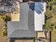 High-angle aerial view showcasing the property's roof, lush surroundings, outdoor entertaining area, and spacious driveway at 1276 Bermuda St, Clearwater, FL 33755