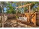 Backyard featuring a charming wooden swing set and a privacy fence creating a relaxing outdoor space at 1276 Bermuda St, Clearwater, FL 33755
