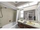 Bathroom featuring a shower-tub combo, an extended vanity counter, and large mirror at 1276 Bermuda St, Clearwater, FL 33755