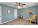 Bedroom with a ceiling fan, wood-look flooring, and light blue colored walls at 1276 Bermuda St, Clearwater, FL 33755