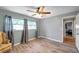 Bedroom featuring wood look flooring, a ceiling fan and large window at 1276 Bermuda St, Clearwater, FL 33755