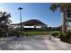 Scenic view of an outdoor amphitheater in a community park, featuring a modern stage, lush lawn, and landscaped surroundings at 1276 Bermuda St, Clearwater, FL 33755