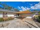 Single-story home featuring an extended carport, well-lit entry, and appealing facade at 1276 Bermuda St, Clearwater, FL 33755