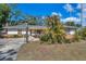 Charming single-story home with a covered entry, a brick accent wall, and mature landscaping at 1276 Bermuda St, Clearwater, FL 33755