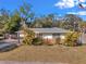 Charming single-story home featuring mature landscaping and a well-manicured lawn, complemented by a quaint design at 1276 Bermuda St, Clearwater, FL 33755
