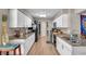 Modern kitchen with granite countertops, white cabinets, and stainless steel appliances at 1276 Bermuda St, Clearwater, FL 33755